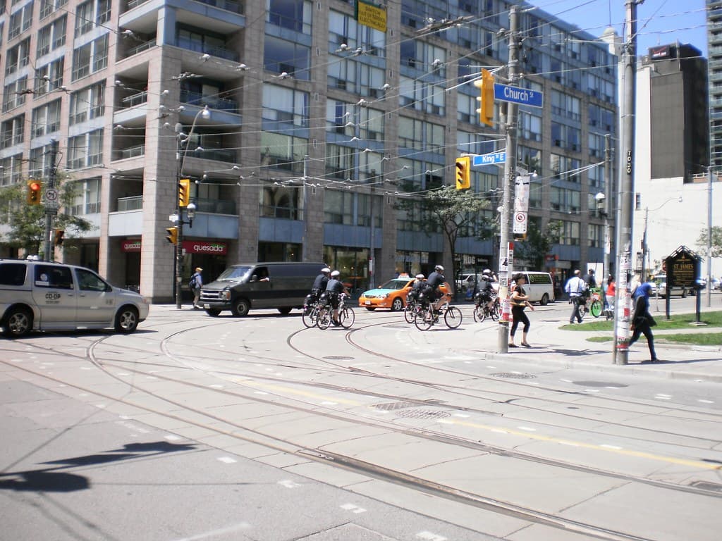 Bicycle cops patrolling Church Street, prior to the G20 -c