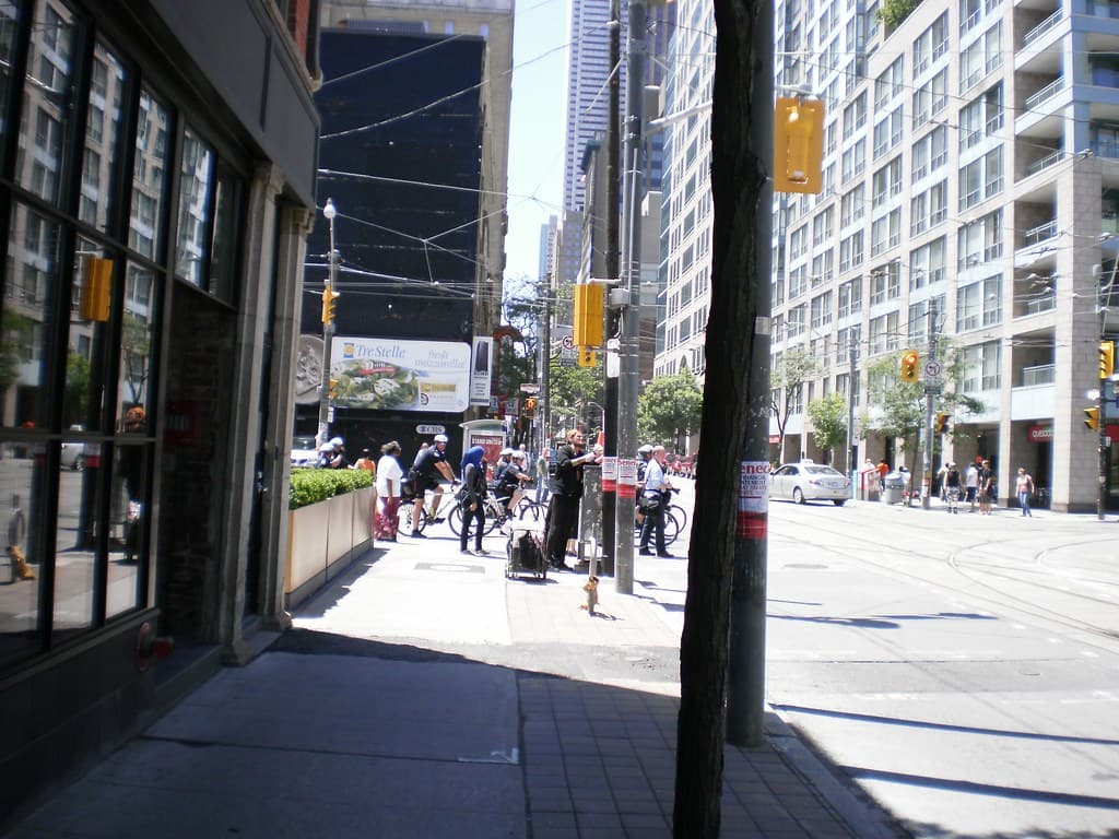 Bicycle cops patrolling Church Street, prior to the G20 -a