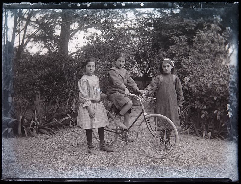 Three children and cycle, c. 1920s?