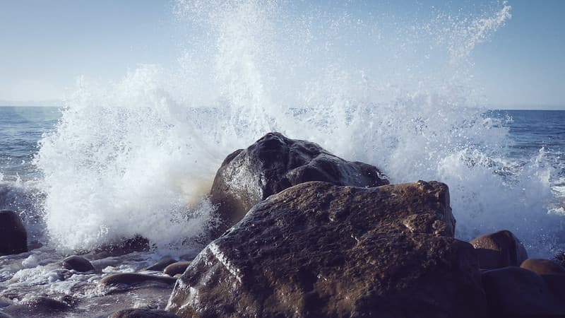 Ocean Wave Splashing Against Rocks