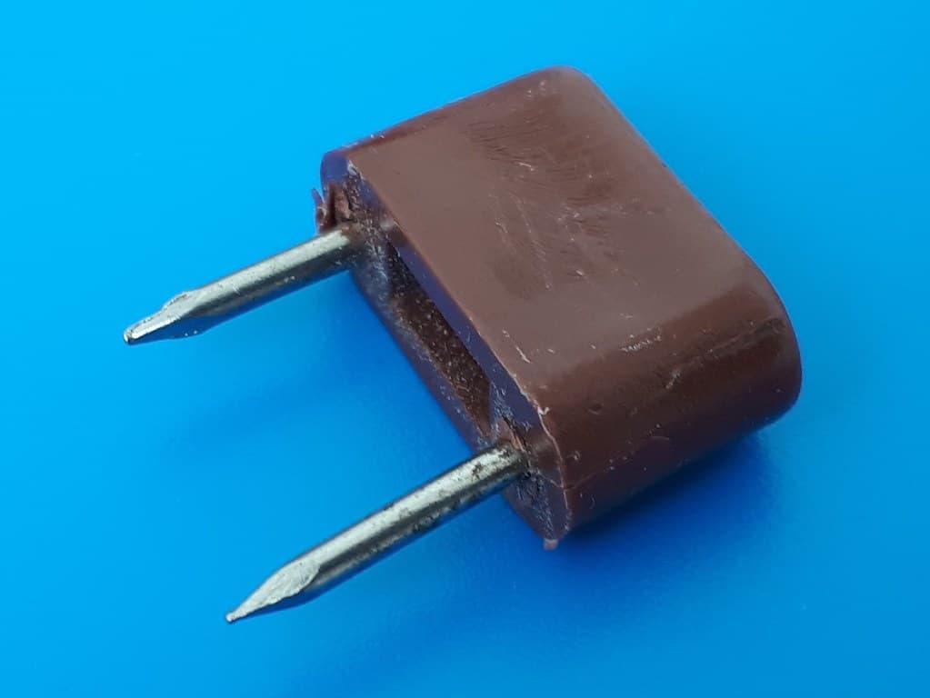 Shelf support with two nails and brown plastic head - on Blue plakene