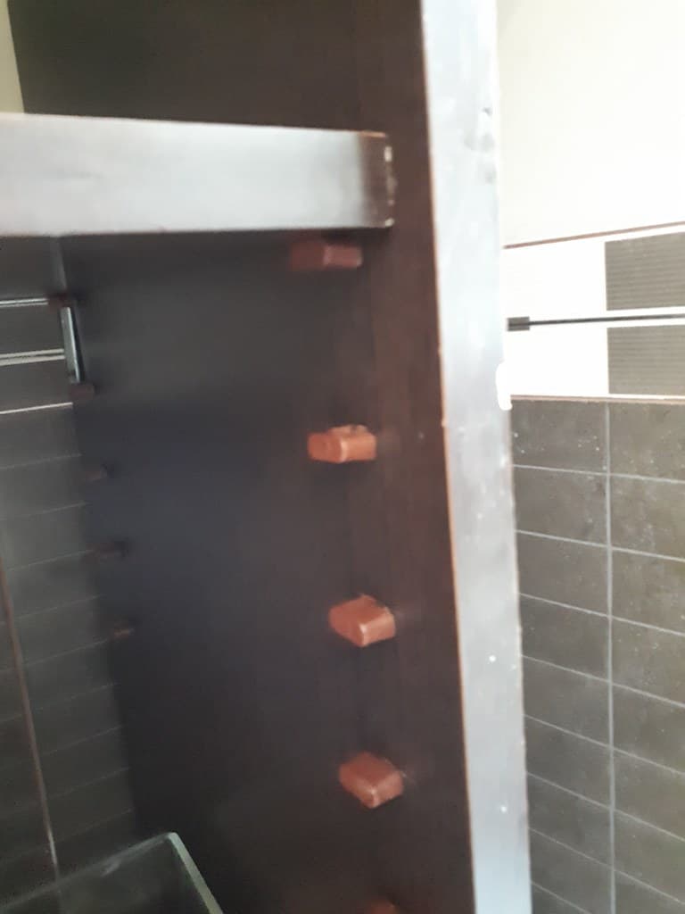 Brown plastic shelf supports with two nails 1