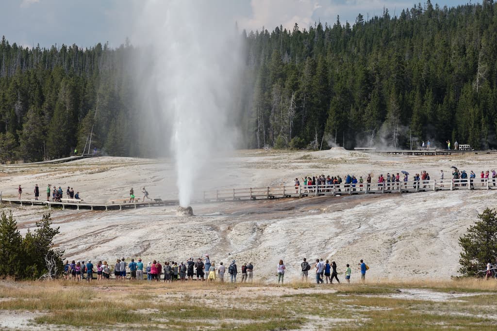 People watching Beehive Geyser erupt