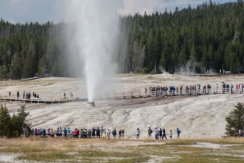 People watching Beehive Geyser erupt