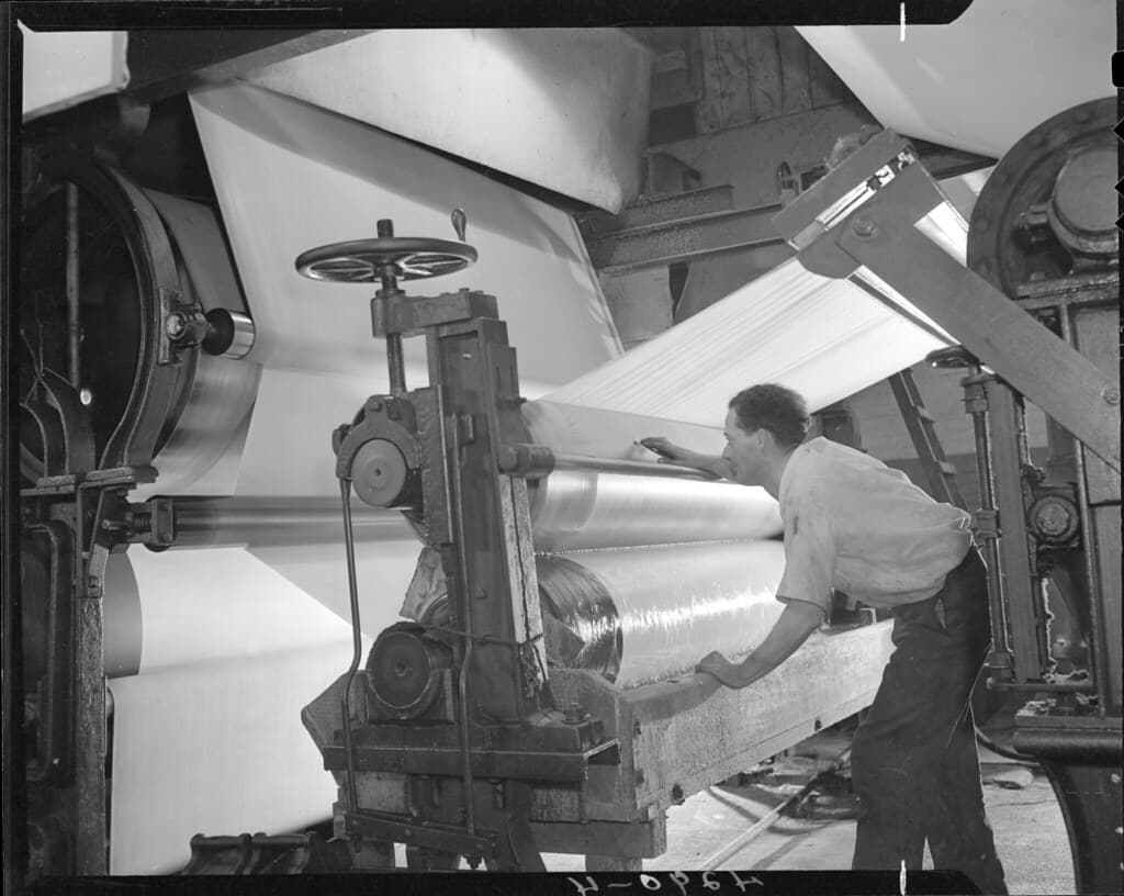 Man working with pulp and paper machinery at Thorold