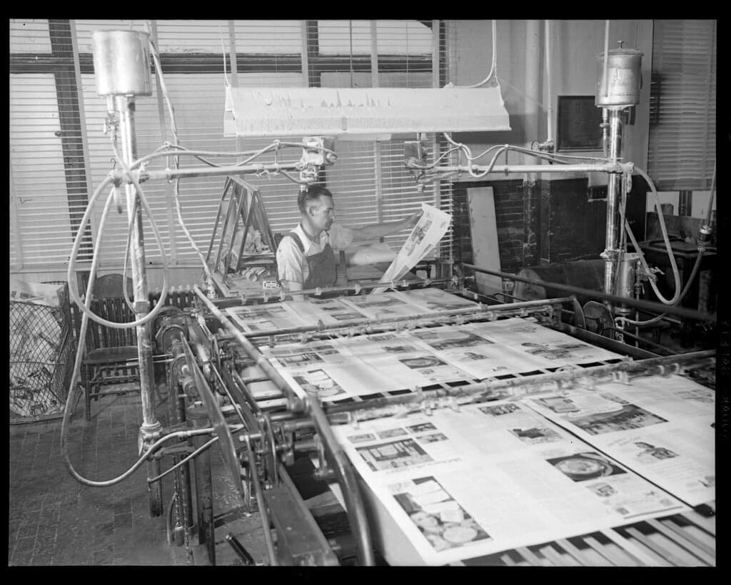 Man with machinery in the Maclean-Hunter printroom