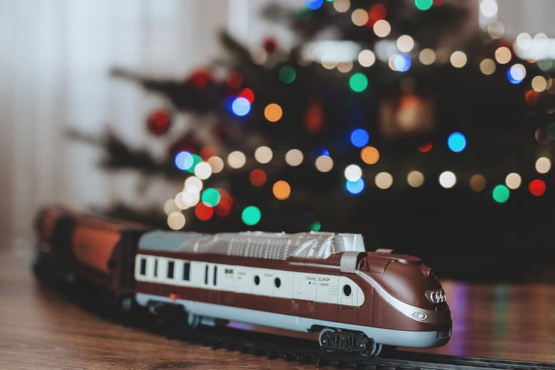 A toy train going around the Christmas tree