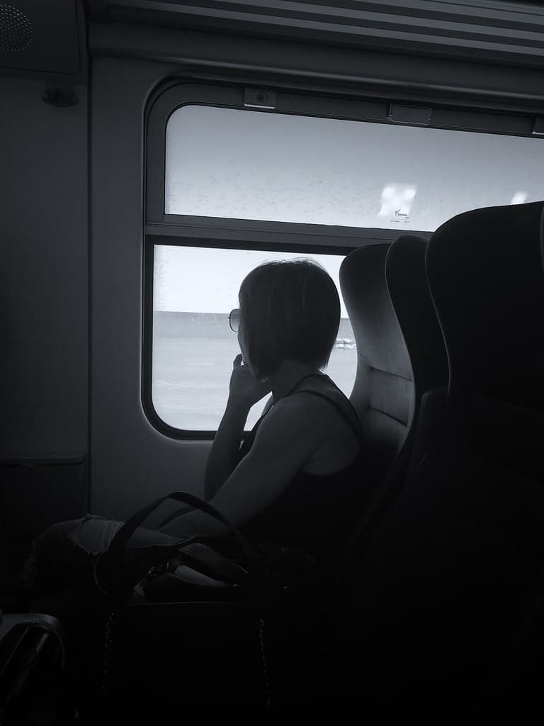 Woman in train, thinking about ...