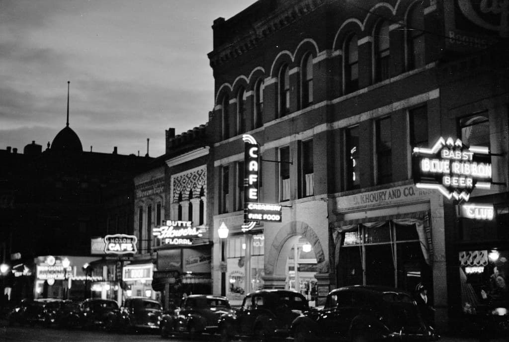 The Lighted Way: Night street scene in Butte, Montana, 1939.