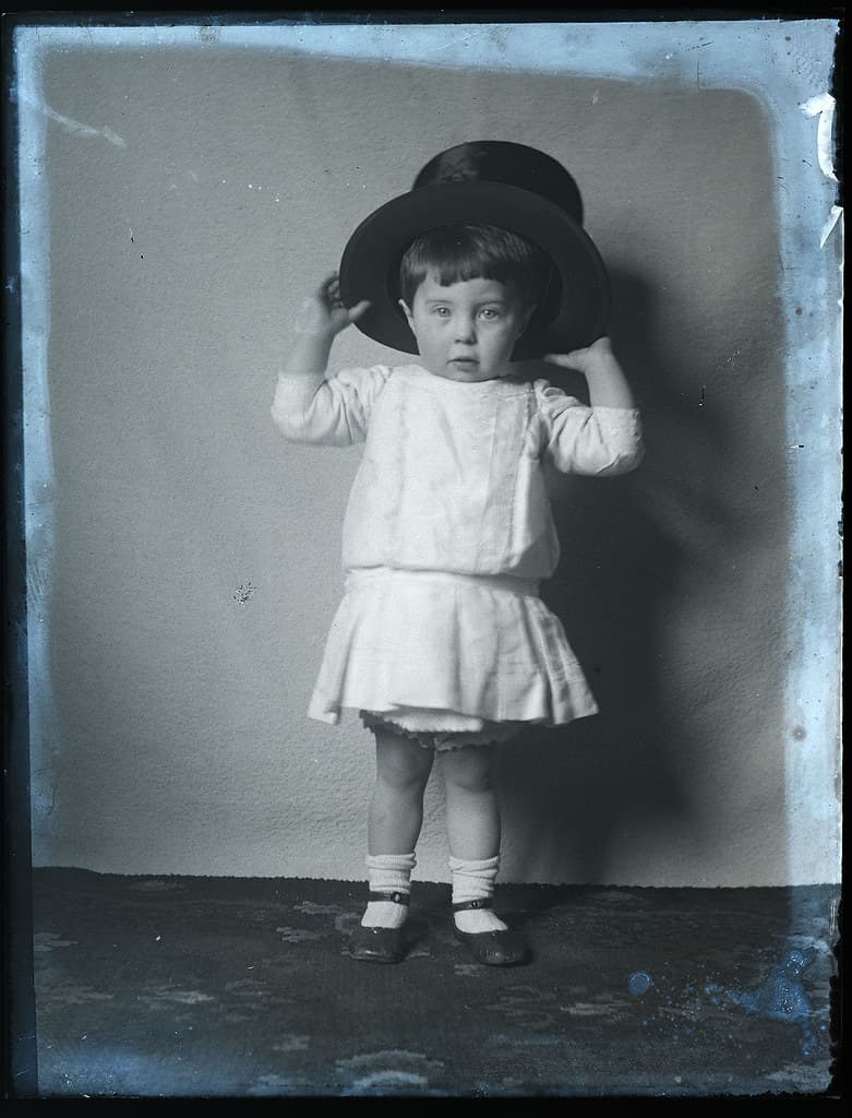 Lovely portrait of child in top hat, early 1900s