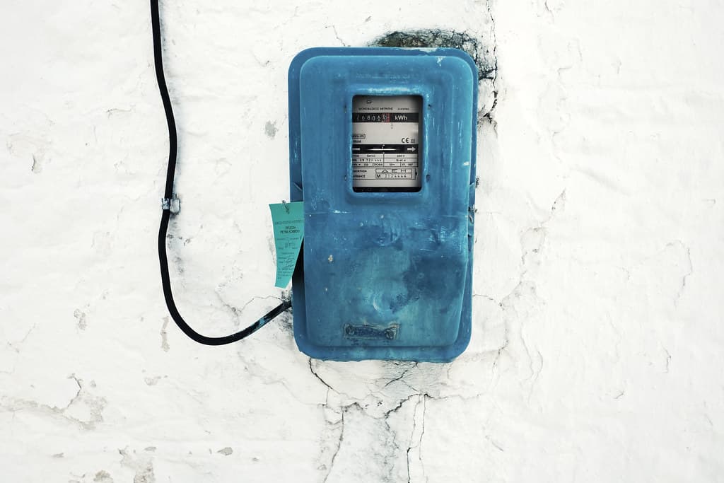 Blue Box Power Meter with Wire on White Wall