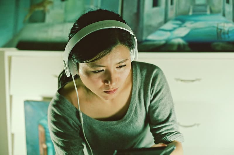 Reading ipad with headphones on