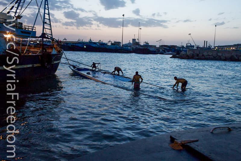 Sunken boat carrying migrants is pulled into the port Zuwara, Libya