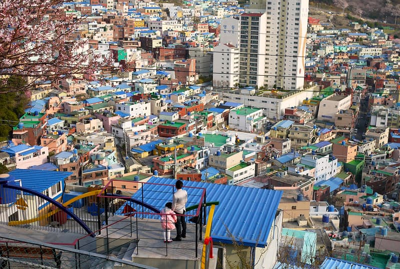 Man and Child on Staircase Overlooking Urban City