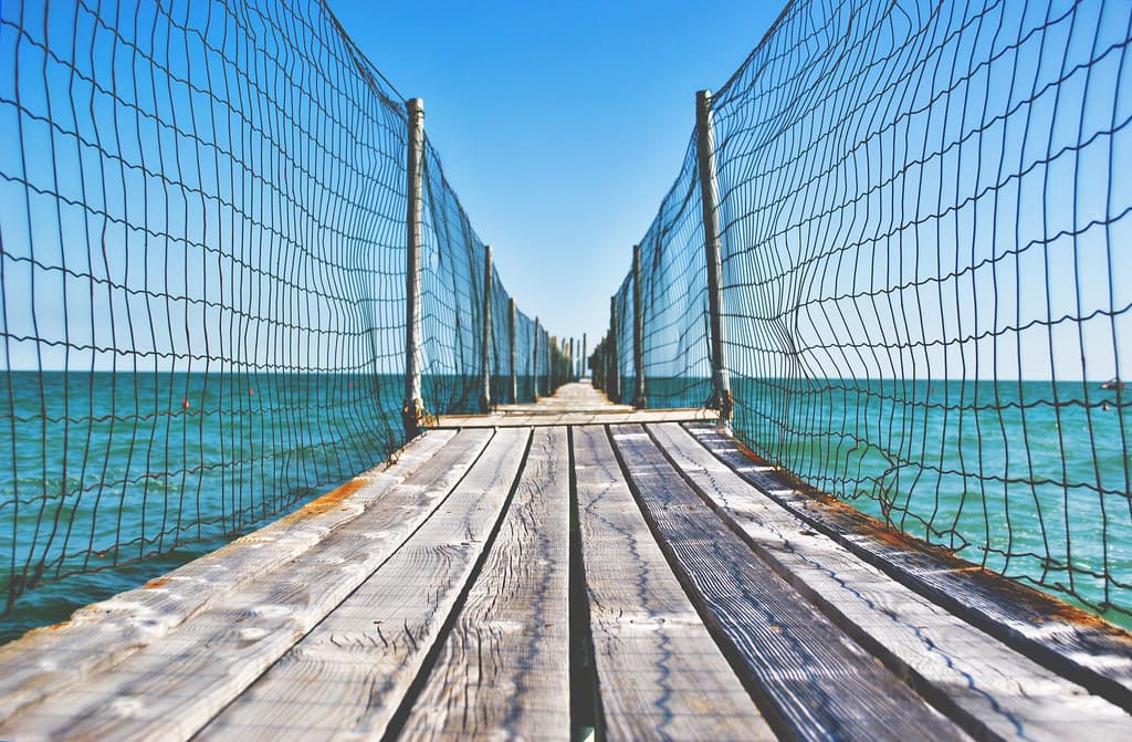 Fenced Wooden Boardwalk Over Ocean