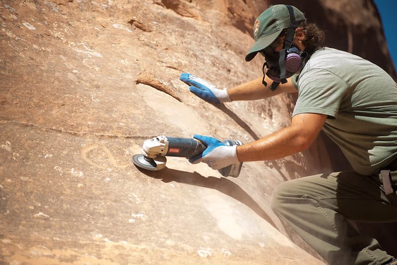 Park Maintenance Staff Use Grinders to Remove Graffiti