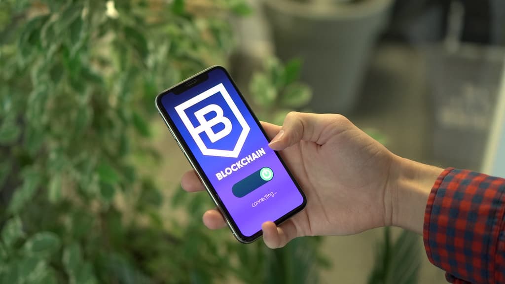 Man connecting to a blockchain platform with a smartphone