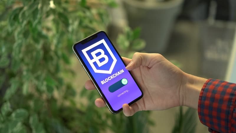 Man connecting to a blockchain platform with a smartphone