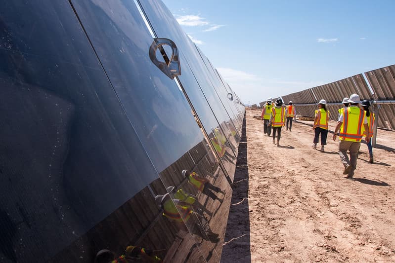 BLM Arizona staff walk through solar panels