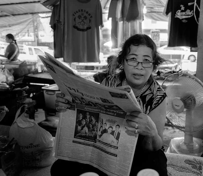Reading woman, Mae Phim market. Thailand
