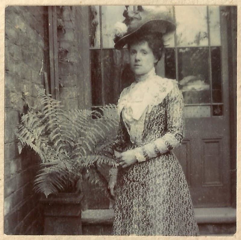 Unknown lady, lovely dress, hat and fern!