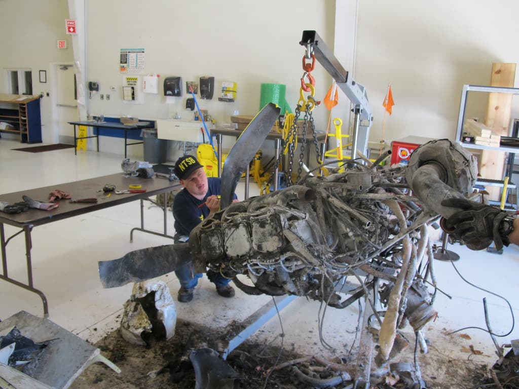 NTSB Intern Jeremy Laurel assisting with engine exam
