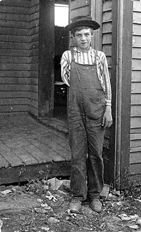 Child Labor: Boy lost arm running saw in box factory, 1909
