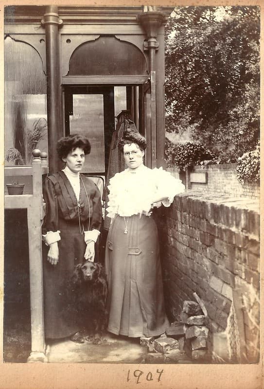 Two Edwardian ladies and a dog, at the back door, 1907
