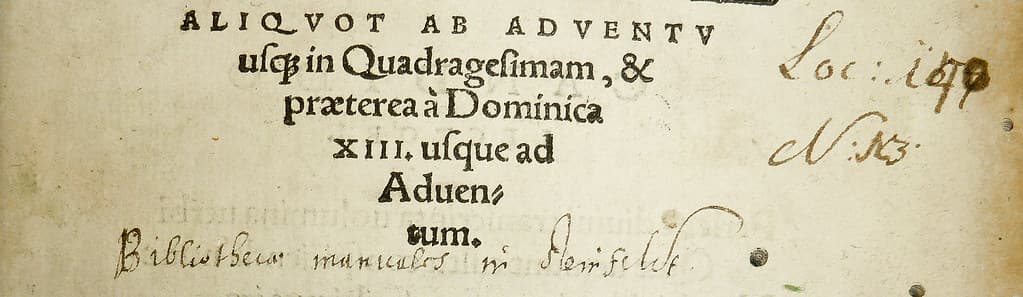 Partially illegible library ownership inscription and shelf-mark