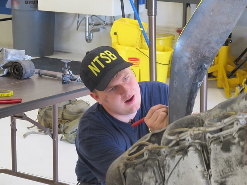 NTSB Intern Jeremy Laurel assisting with engine exam