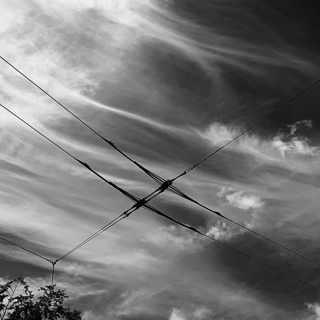 10th trolley bus wires fluffy clouds