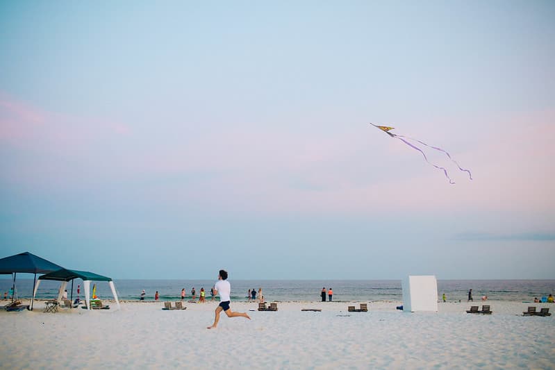 Male Flying a Kite on an Ocean Beach