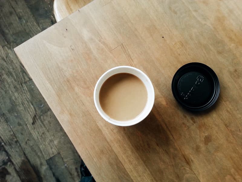 Coffee in Cup with Lid on Tabletop