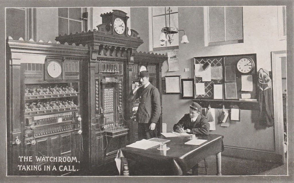 Taking a call in the Watchroom - Fire Brigade Series postcard