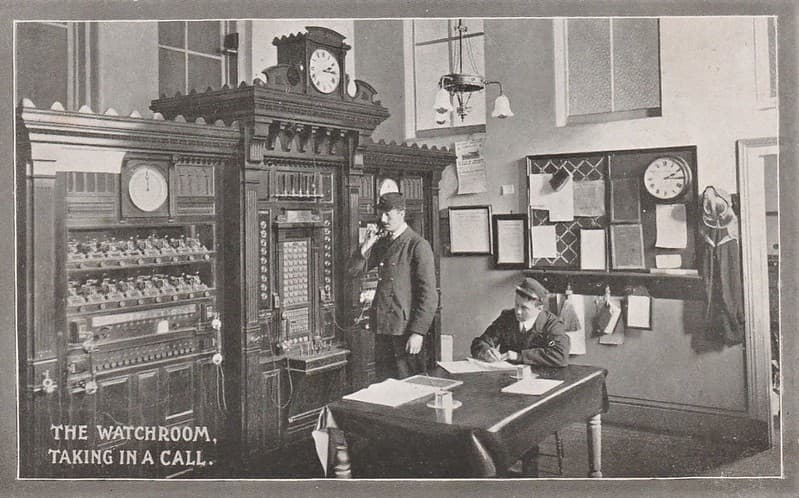 Taking a call in the Watchroom - Fire Brigade Series postcard