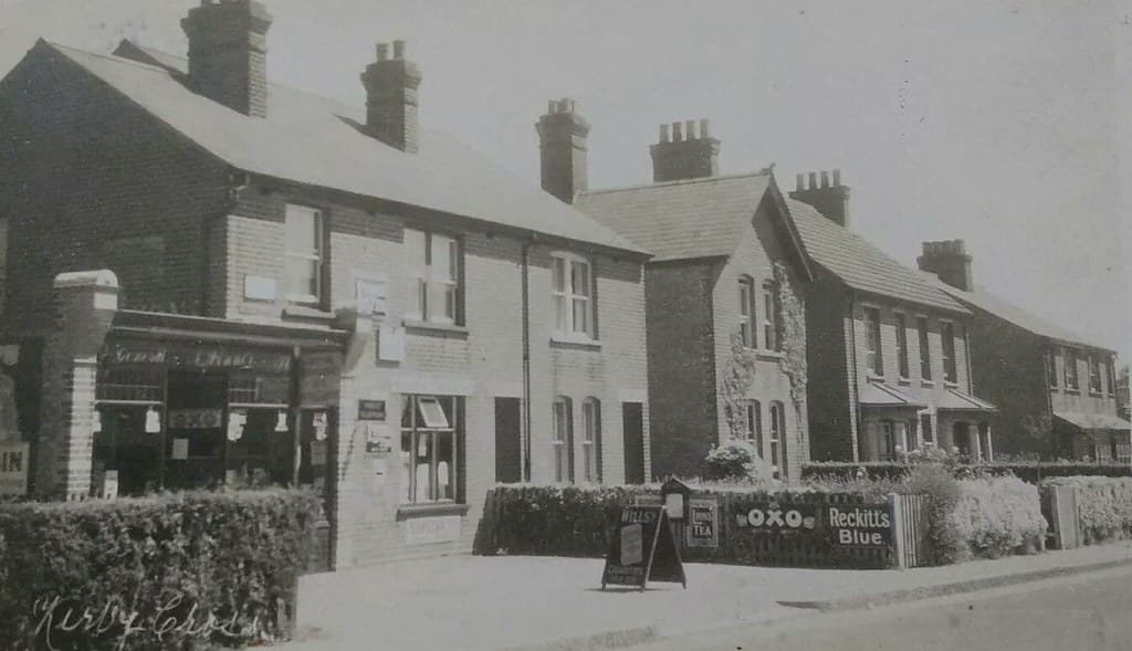 KIRBY CROSS NEAR FRINTON ON SEA SHOP FRONT ADVERTISING 1929 POSTCARD