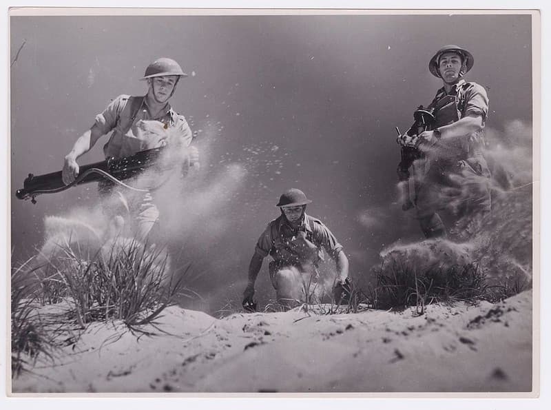 Soldiers running with machine guns, ca1940