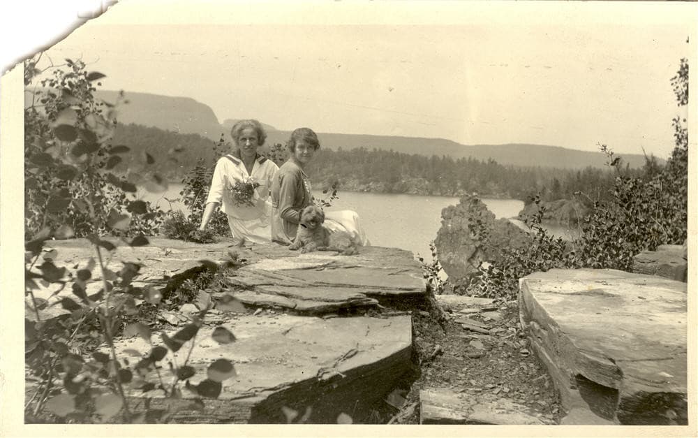 Two women sitting with dog