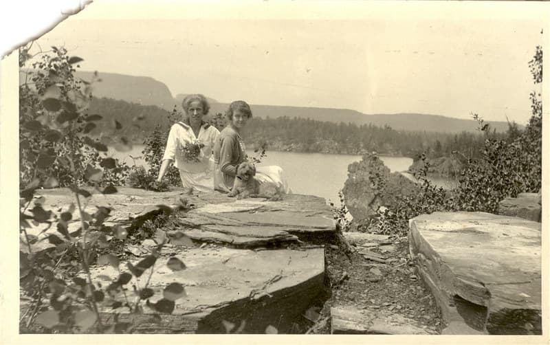 Two women sitting with dog