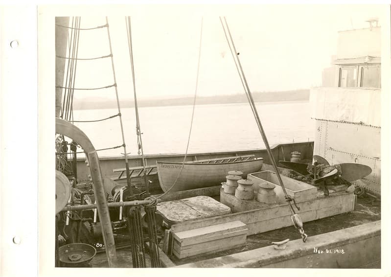 View of deck of boat being equipped, note lifeboat and propeller