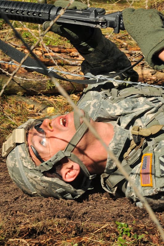 Harris low crawls under barbed wire