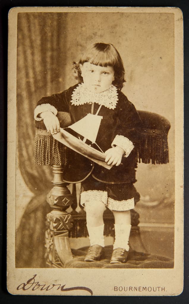 Young boy and his toy boat, by Down, Bournemouth