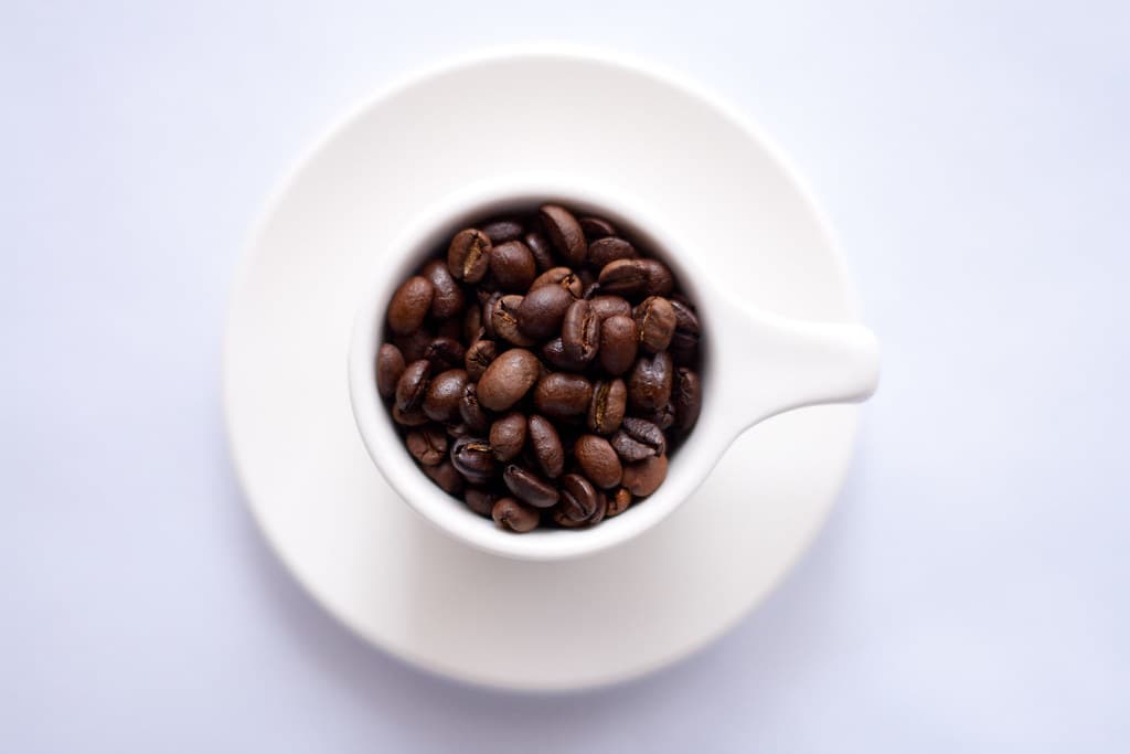 White Cup Full of Coffee Beans