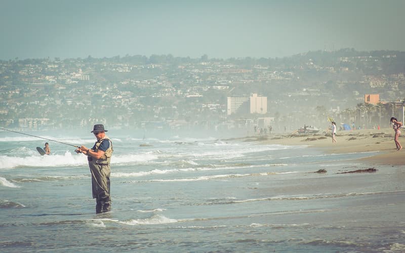Man Fishing on Ocean Beach
