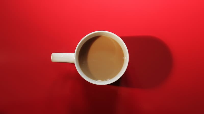 Coffee Cup with Coffee on Red Background