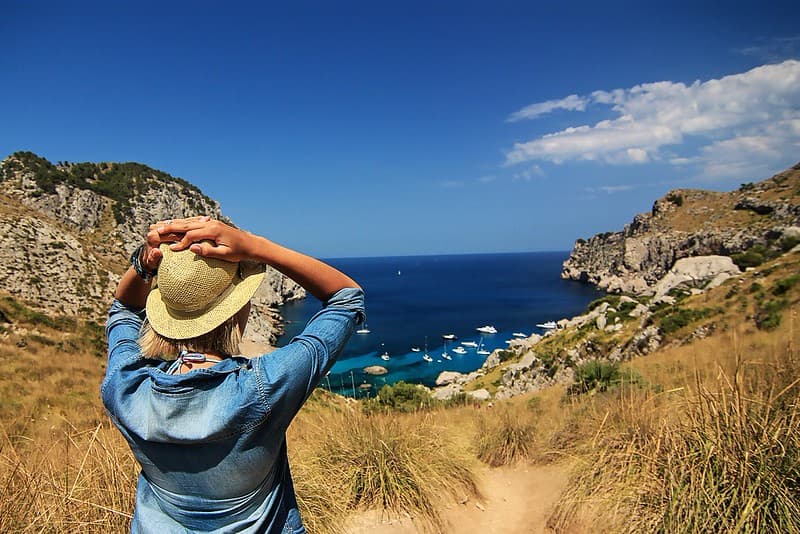 Female in a Blue Jean Shirt Viewing Ocean Shore