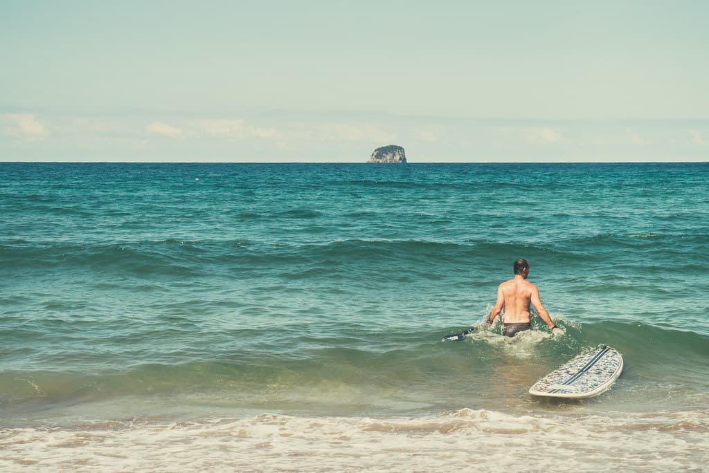 Male Surfer with Surfboard in Ocean