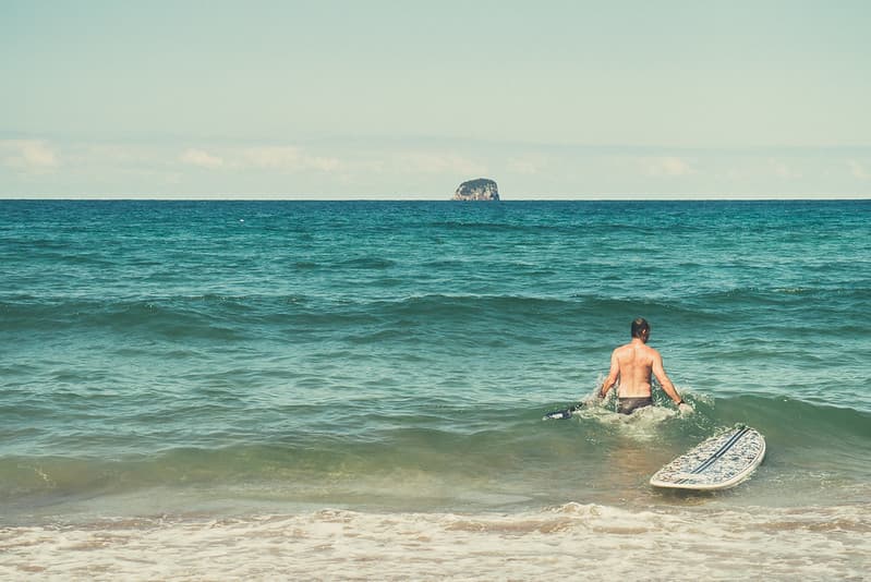Male Surfer with Surfboard in Ocean