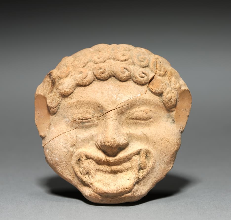 Gorgoneion Plaque with Incised Figure of a Dancing Satyr
