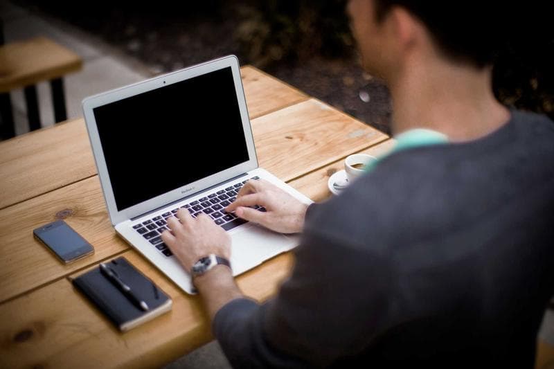 Typing at a laptop
